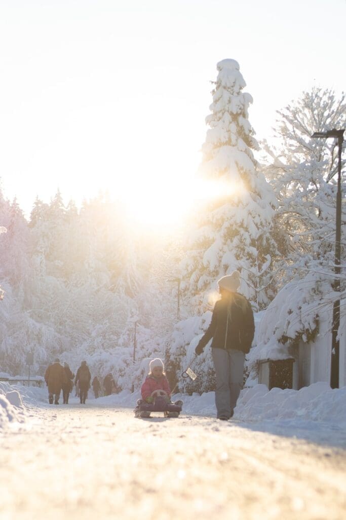 people sitting on snow covered ground during daytime