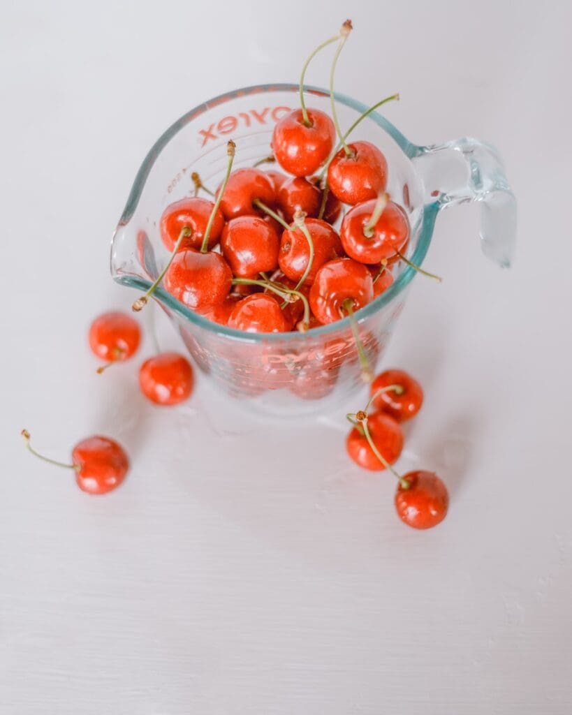 red cherries in clear glass bowl