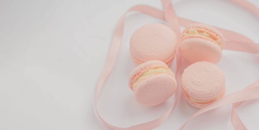 pink and white macaroons on white surface